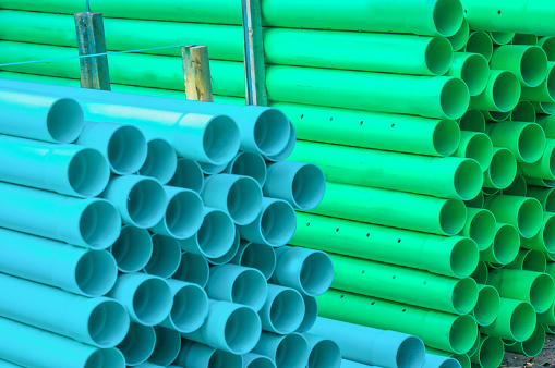 Stacks of blue and green water pipes at a Vermont construction site.