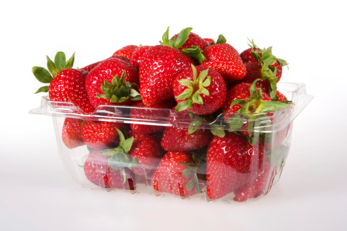 Open pack of fresh red ripe strawberries.