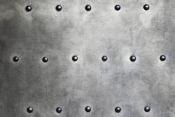 Black grunge metal plate or armour texture with rivets as background