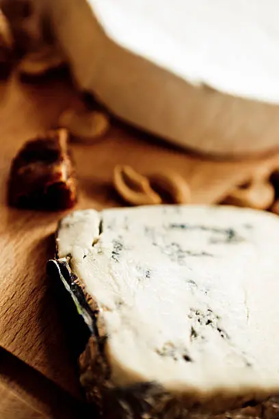 Part of a cheeseplate: blue cheese and Camembert with dried figs and nuts.