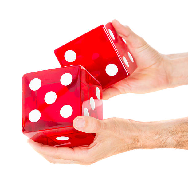 Big Dice Hands holding a large pair of dice against a white background. giant cube stock pictures, royalty-free photos & images