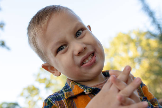 istock Sweet toddler with blue eyes eating a chocolate cookie makes crazy faces 1742646605