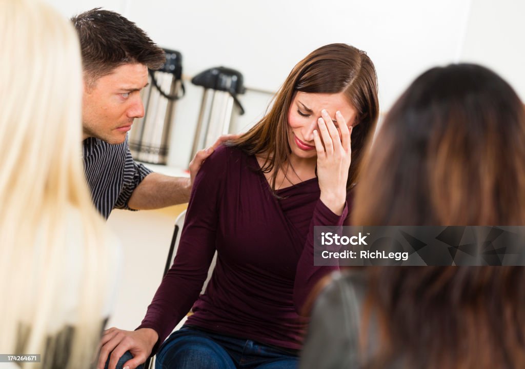 Support Group A woman sharing her emotions in a support group. 30-39 Years Stock Photo