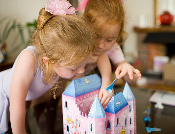 istock Kids playing together with doll house 174264918