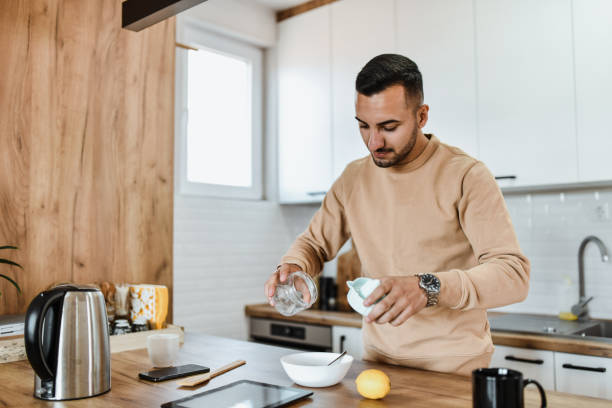 istock Male Putting Squeezed Lemon Juice In Bowl 1742655423