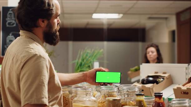 istock Man uses mockup phone in bio supermarket 1742657763
