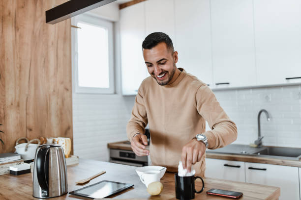 istock Smiling Male Preparing Breakfast And Lemon Juice For Tea 1742657924