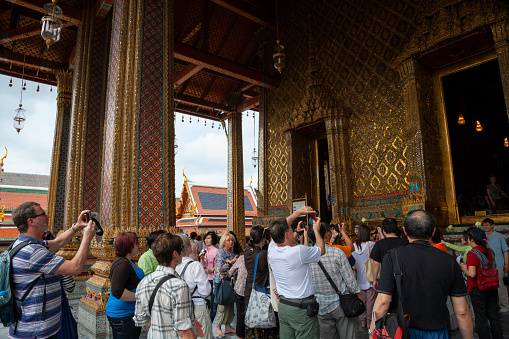 Bangkok Thailand - April 5, 2011: Group of tourists at Wat Phra Kaew in the grounds of the Royal Grand Palace