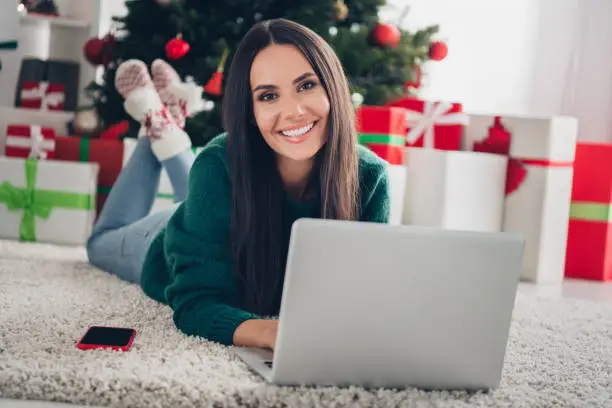 Photo of dreamy pretty girl wear xmas green pullover communicating samsung apple modern device indoors home room.