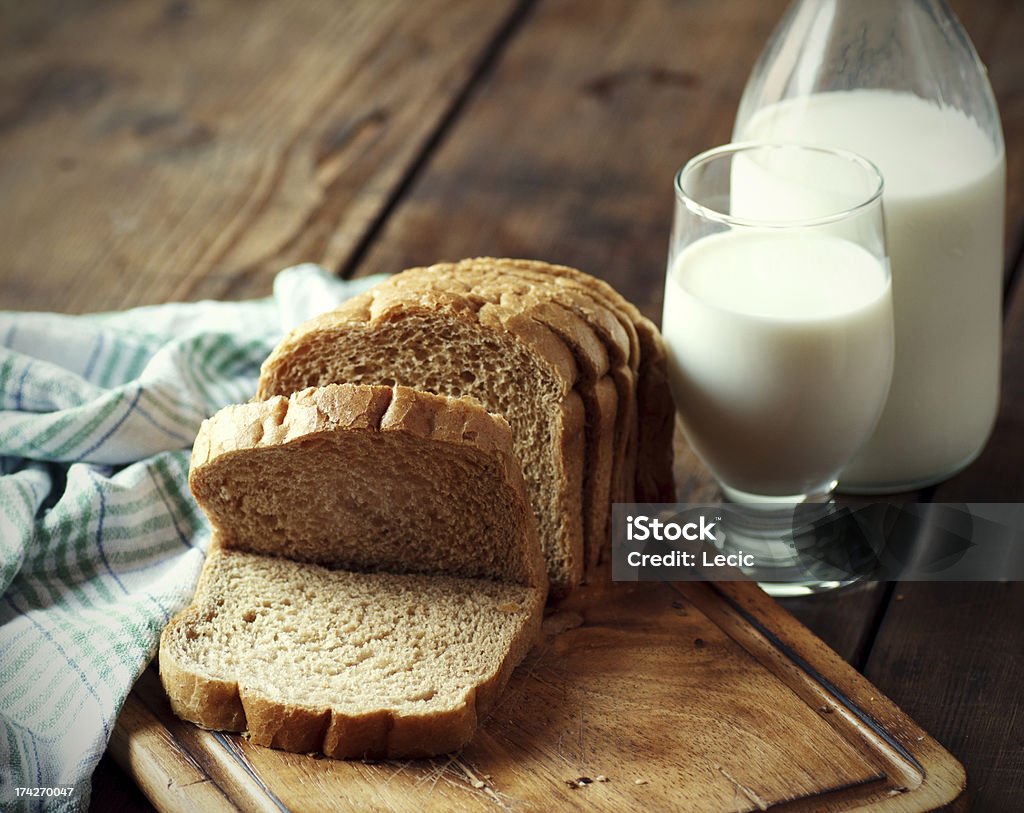 Whole grain bread with a glass of milk Whole grain bread with a glass of milk on wooden table Bread Stock Photo