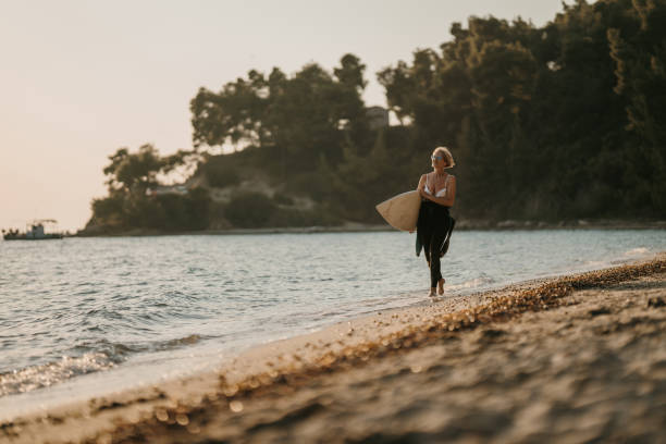 istock Mature woman surfer on the beach 1742703381
