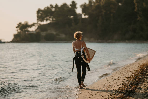 istock Woman surfer on the beach 1742704484