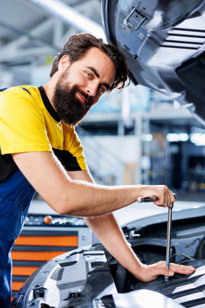istock Happy garage worker replaces car brakes 1742705121