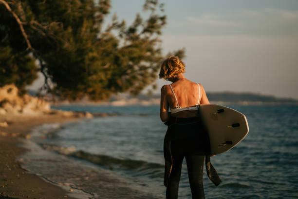 istock Woman surfer by the sea 1742706981