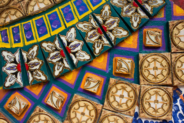 Handicraft retro tracery design ceramic and craft vintage marble tiles patterns on wall with graffiti street art in antique market 100 year arch bridge at Suratthani old town in Surat Thani, Thailand