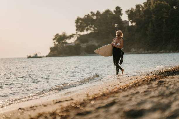 istock Woman surfer on the beach 1742709489