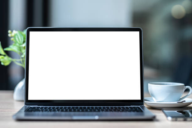 istock Mockup of laptop computer with empty screen with coffee cup and smartphone on table of the coffee shop background,White screen 1742720893