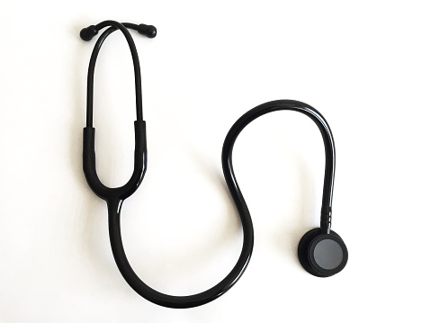 A black stethoscope on white background with copy space
