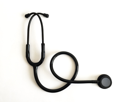 A black stethoscope on white background with copy space