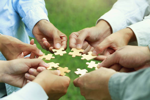 istock CSR  corporate social responsibility. teamwork and partnership concept. business people putting the Jigsaw team together. Charity, volunteer. Unity, team business and environmental concern. 1742737821