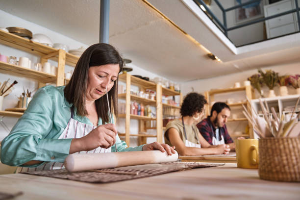 istock Woman working with clay in a pottery workshop. 1742747606