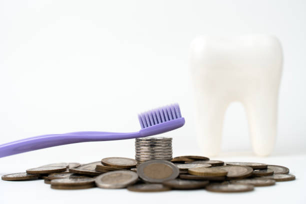 istock Tooth brush and money coins on a white background 1742747696