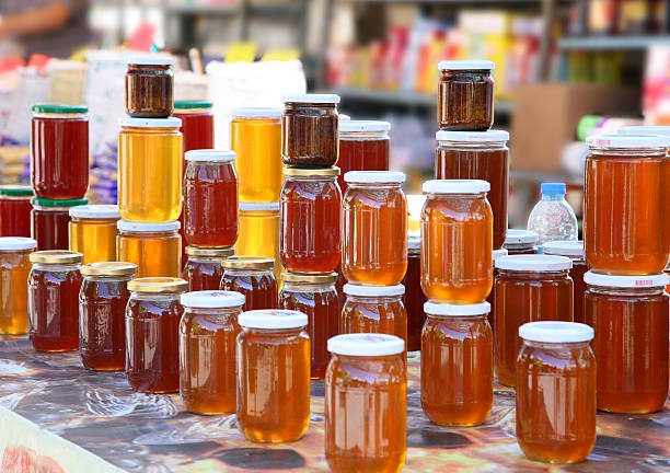 Honey Jars of honey on display for sale. agricultural fair stock pictures, royalty-free photos & images