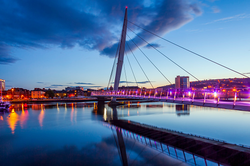 Blue hour reflections at the Sail Bridge on the River Tawe at the marina in Swansea, Wales