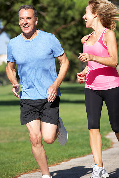 istock Couple jogging in a park 174277611