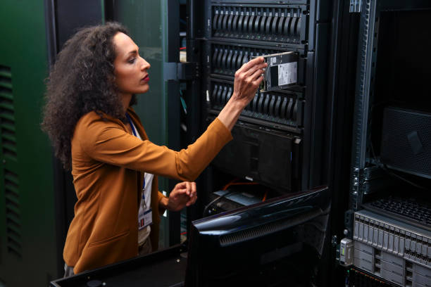 Changing drive in server installation in large datacenter stock photo