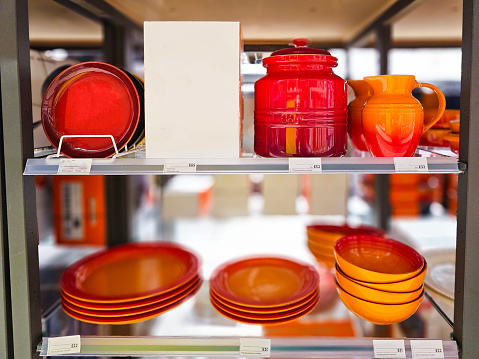A collection of colorful stoneware crockery on display in the store.