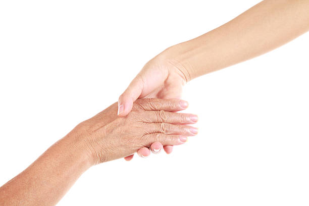 Close-up of younger and older person holding hands Gesture on white background hand massage photos stock pictures, royalty-free photos & images