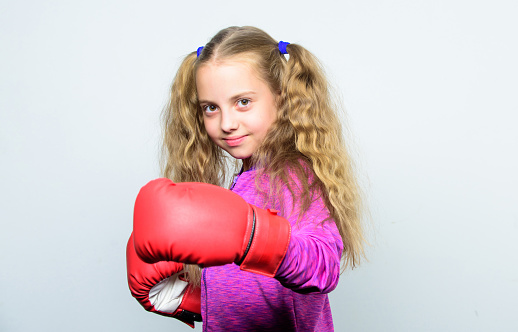 Boxing sport for female. Skill of successful leader. Sport upbringing. Girl cute child with red gloves posing on white background. Upbringing for leader. Strong child boxing. Sport and health concept.