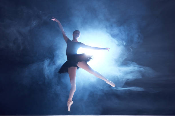 istock Artistic, talented young woman, professional ballerina making creative performance on sage with smoke effect 1742806476