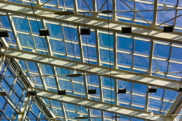 istock Ceiling structure made of metal and glass. Blue sky view 1742809355