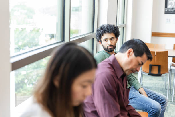 istock Young man looks away while thinking in waiting room 1742810596