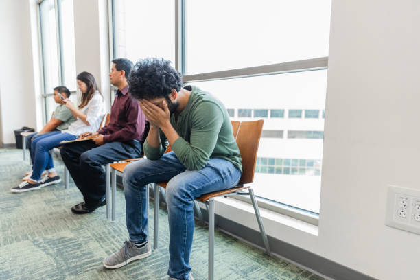 istock In waiting room, exhausted young man covers face with hands 1742810602