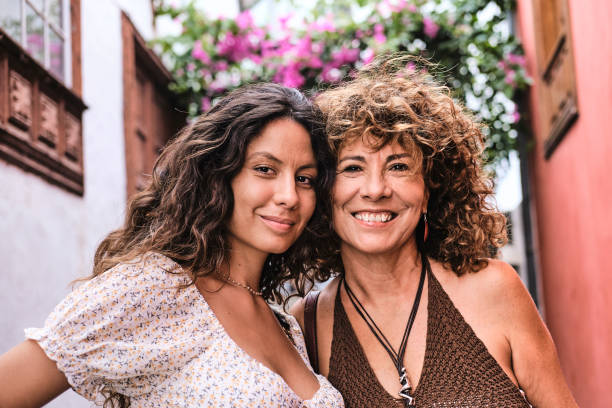 istock Mother and daughter pose on an old charming street 1742817486