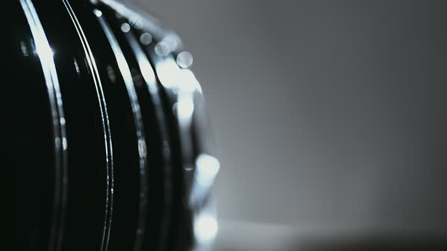 Close-up camera pan shiny reflective black metallic surface of a brand new waxed car grilles