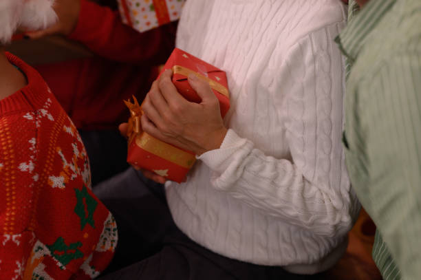 istock Close up of hands holding Christmas gift boxes 1742821437