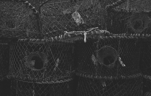A black and white photograph of crab nets