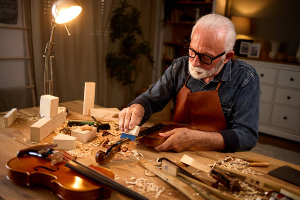 istock Senior carpenter craftsman making violin instrument 1742832368