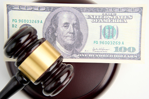 Judge gavel and Dollar money on white background, close-up, selective focus image. Judgement bribe and corruption concept