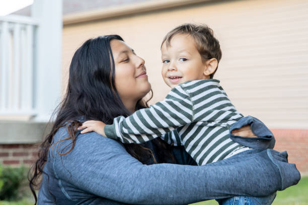 istock A young mother hugs her little boy while bonding over bubble-blowing in the front yard 1742836608