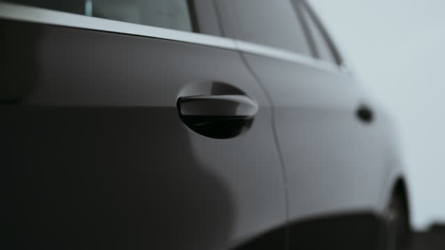 Camera pan shiny reflective surface of a brand new waxed car doors