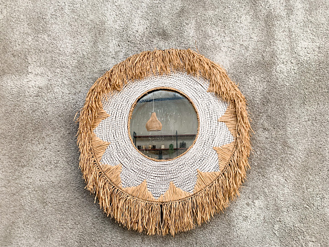 bohemian mirror decoration on the rough surface wall