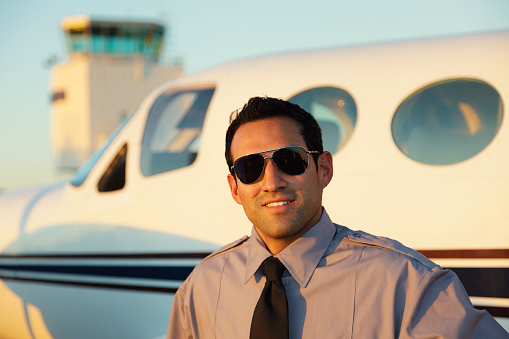 A man standing in front of a corporate airplane.
