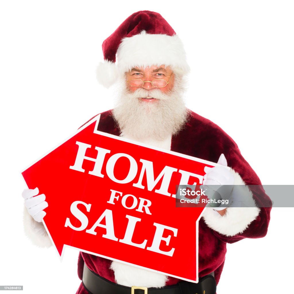 Santa Claus with a Real Estate Sign Santa Claus holding a house shaped real estate sign. Real Estate Stock Photo