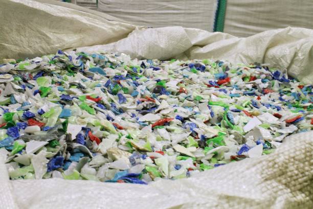 istock Shredded plastic pieces prepare for recycling. Raw cables material for reproduction. Sorting garbage on waste plant. Pile of scrap bottles on trash storage factory. Environmental concept 1742848779