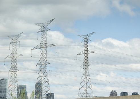 Three transmission towers stand near Highway 400.